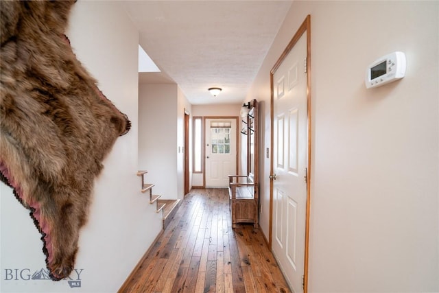 hallway featuring stairs and hardwood / wood-style flooring