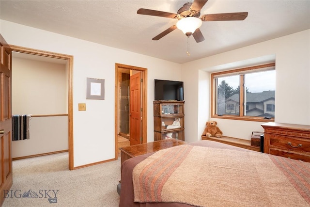 bedroom featuring a ceiling fan, light colored carpet, and baseboards