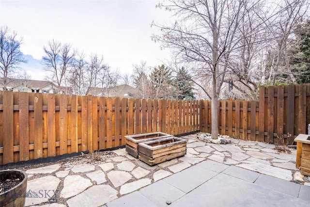 view of patio with a fenced backyard and a fire pit