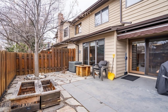 view of patio / terrace featuring central air condition unit and fence