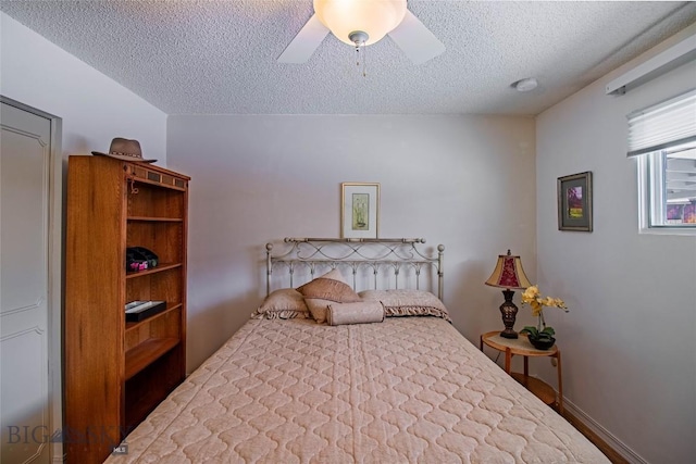 bedroom with a textured ceiling and ceiling fan