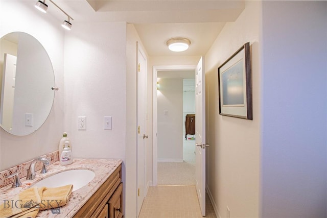 bathroom with baseboards and vanity