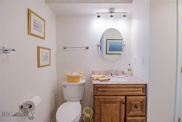 bathroom with toilet and vanity