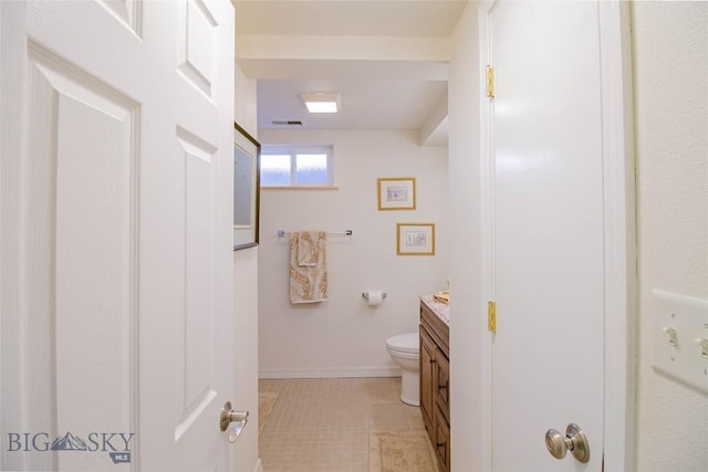 bathroom featuring tile patterned flooring, visible vents, baseboards, toilet, and vanity