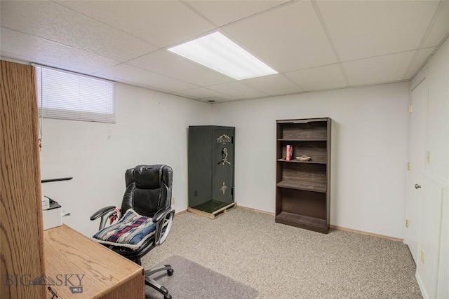 carpeted home office featuring a drop ceiling and baseboards