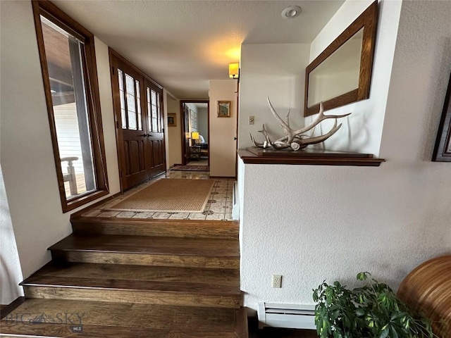 interior space featuring wood finished floors and baseboard heating