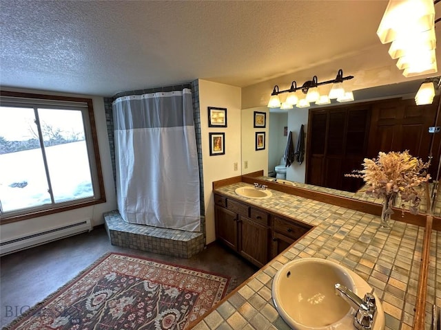 bathroom with curtained shower, a textured ceiling, vanity, and a baseboard heating unit