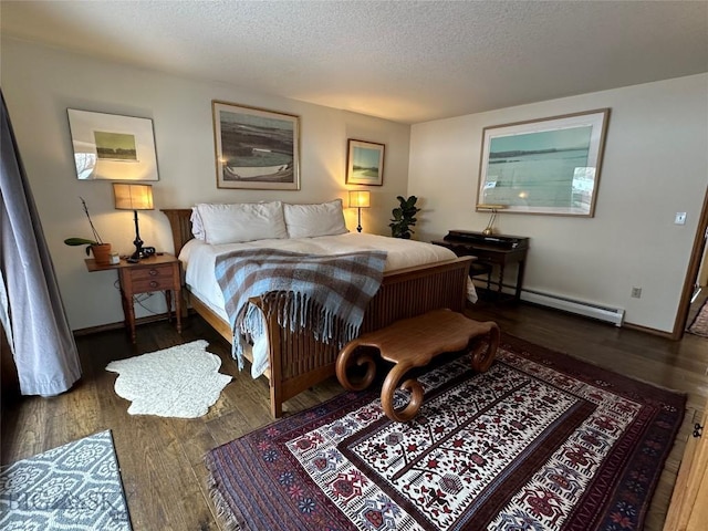 bedroom featuring a textured ceiling, a baseboard heating unit, baseboards, and wood finished floors