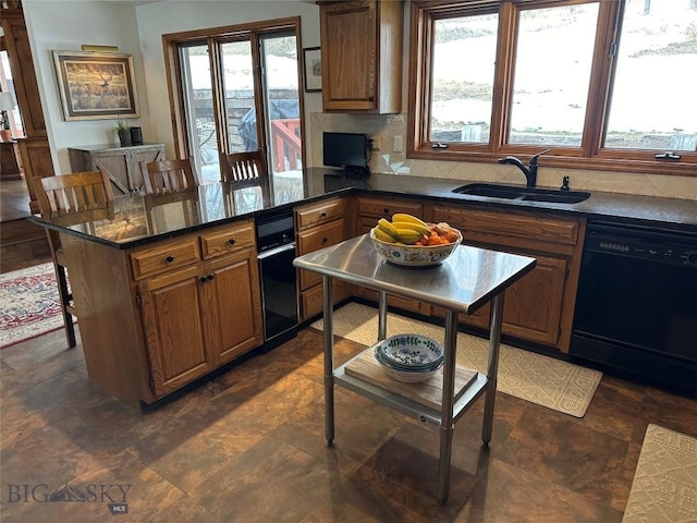 kitchen with a sink, brown cabinets, black dishwasher, and a peninsula