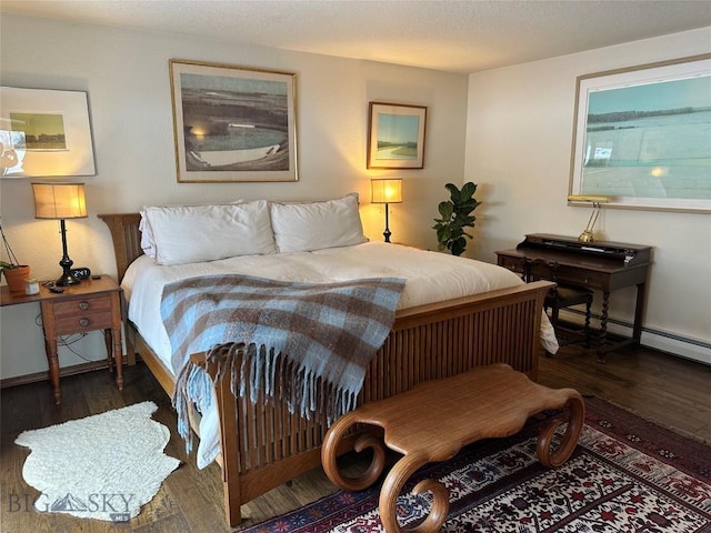 bedroom with wood finished floors and baseboards