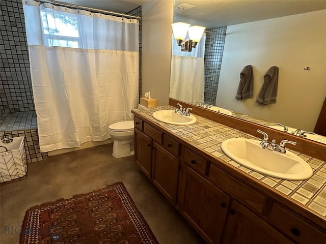 bathroom with a shower with shower curtain, toilet, double vanity, and a sink