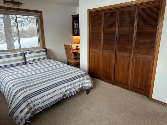 bedroom featuring a closet and light colored carpet