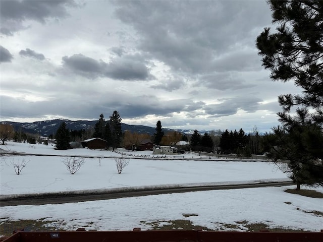 snowy yard featuring a mountain view