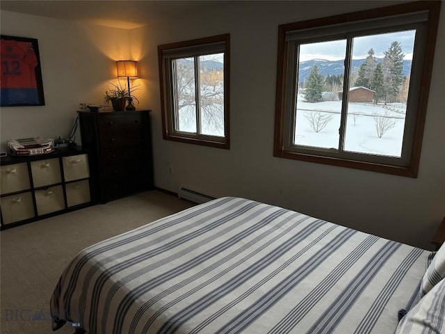 bedroom featuring light carpet, baseboard heating, and a mountain view