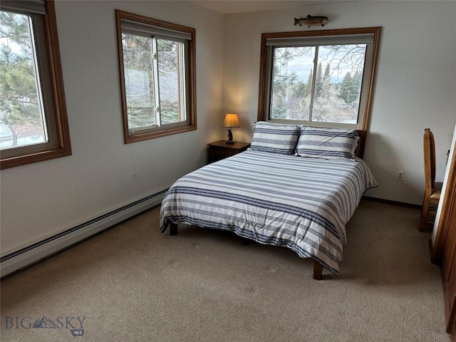 bedroom with a baseboard heating unit and carpet