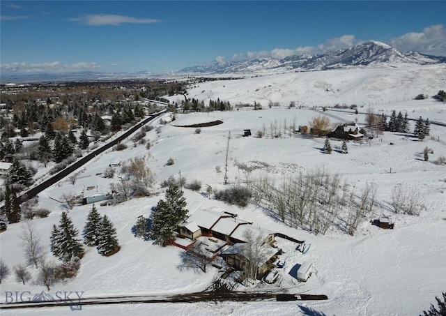 snowy aerial view featuring a mountain view