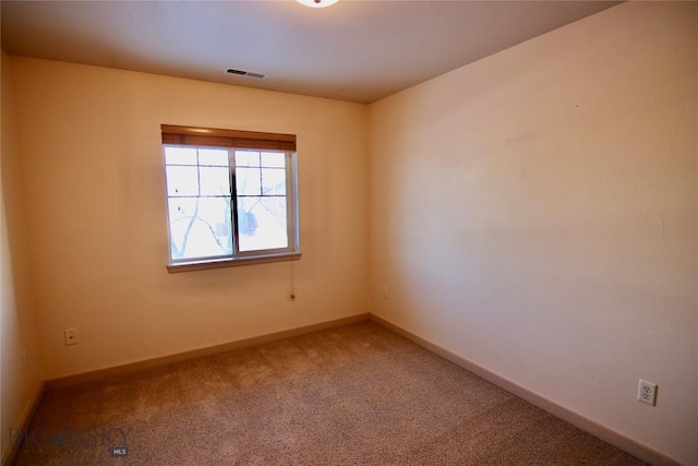 unfurnished room featuring carpet flooring, baseboards, and visible vents