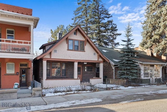 view of front of property featuring a porch and fence