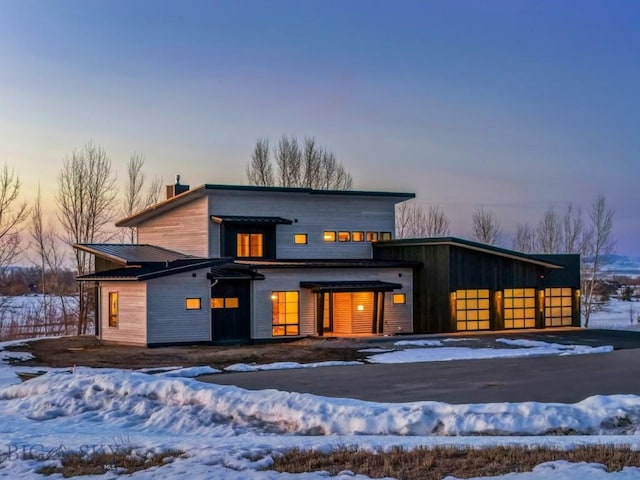 contemporary home with a garage and a chimney