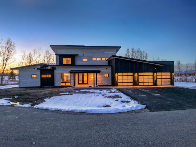 view of front of house featuring aphalt driveway and an attached garage