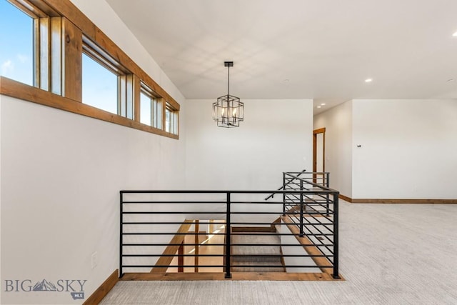 stairway with baseboards, carpet floors, recessed lighting, and a chandelier