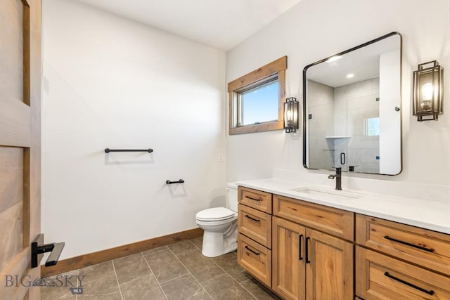 full bath with tile patterned floors, toilet, vanity, a shower stall, and baseboards