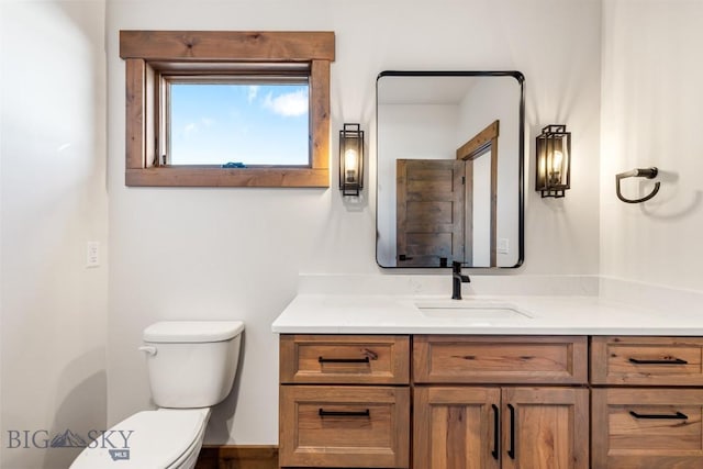 bathroom with toilet and vanity