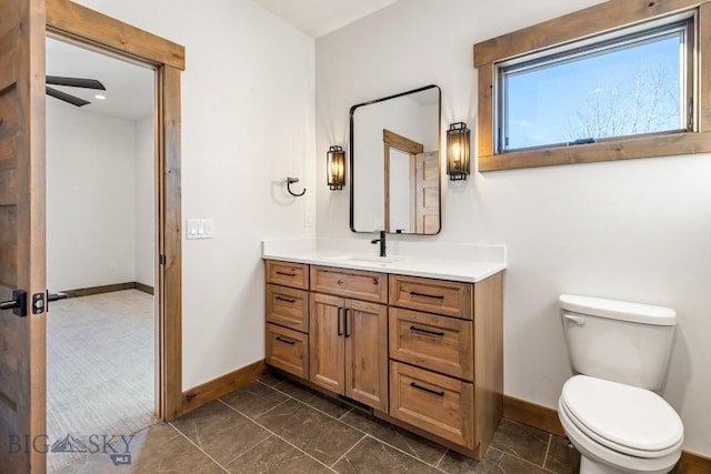 33 Leachman Ln, Bozeman, MT 59718 - bathroom with baseboards, vanity, toilet, and marble finish flooring