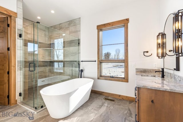 33 Leachman Ln, Bozeman, MT 59718 - full bath with baseboards, vanity, a freestanding bath, marble tiled floors, and a stall shower