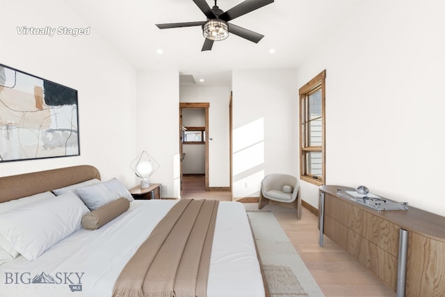 bedroom with a ceiling fan, recessed lighting, light wood-type flooring, and baseboards