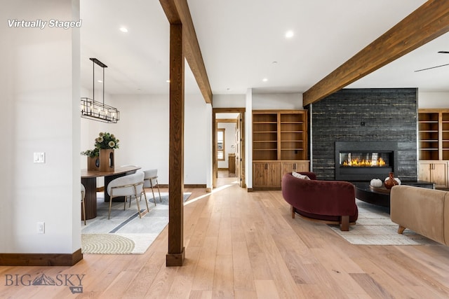 living room featuring beam ceiling, recessed lighting, light wood-style flooring, and baseboards