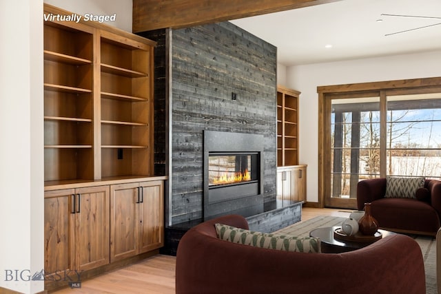 living area featuring a fireplace and light wood-style floors