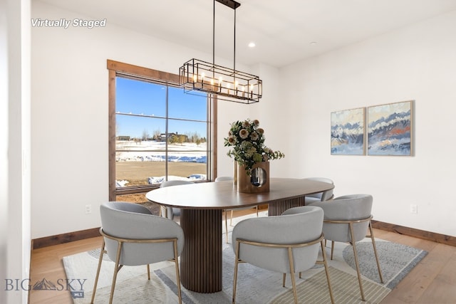 dining room with a chandelier, recessed lighting, baseboards, and wood finished floors