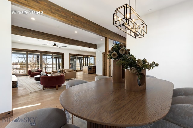 dining area featuring beam ceiling, recessed lighting, ceiling fan with notable chandelier, and wood finished floors