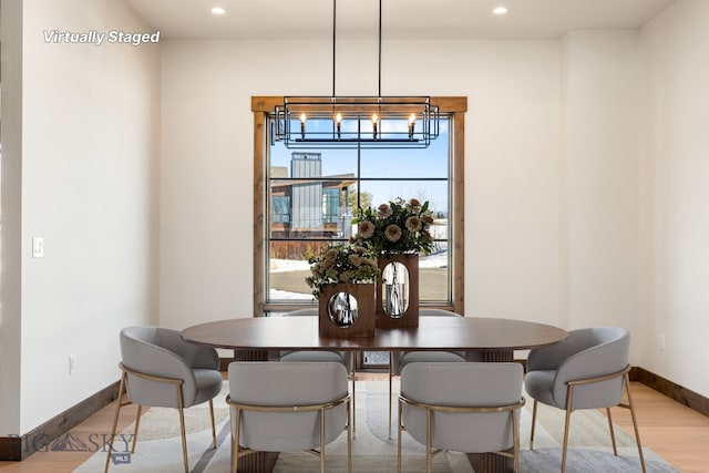 dining area with recessed lighting, baseboards, a chandelier, and light wood finished floors