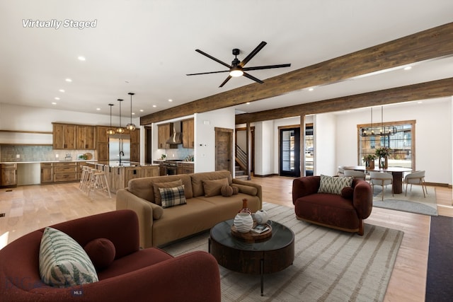 living area with stairway, beamed ceiling, recessed lighting, and light wood-type flooring