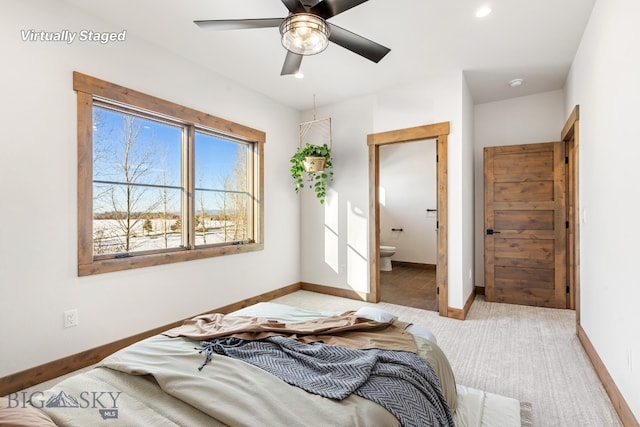 carpeted bedroom featuring recessed lighting, baseboards, ensuite bath, and ceiling fan