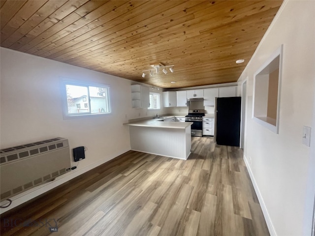 kitchen with a peninsula, wood ceiling, light wood-type flooring, and appliances with stainless steel finishes