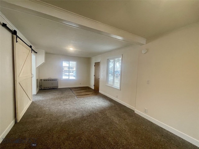 interior space with baseboards, radiator heating unit, a barn door, and dark colored carpet