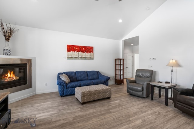 2465 Lasso Ave, Bozeman, MT 59718 - living area with wood finished floors, a glass covered fireplace, recessed lighting, and high vaulted ceiling