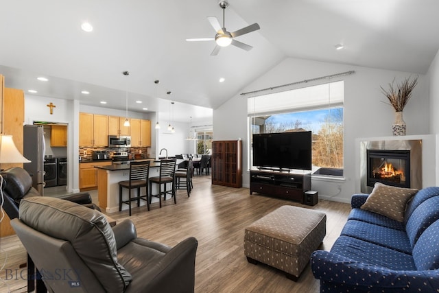 2465 Lasso Ave, Bozeman, MT 59718 - living room featuring a ceiling fan, wood finished floors, high vaulted ceiling, a fireplace, and recessed lighting