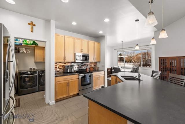 2465 Lasso Ave, Bozeman, MT 59718 - kitchen with appliances with stainless steel finishes, separate washer and dryer, dark countertops, decorative backsplash, and recessed lighting