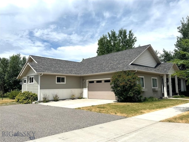 2465 Lasso Ave, Bozeman, MT 59718 - ranch-style home featuring a garage, driveway, a front lawn, and a shingled roof