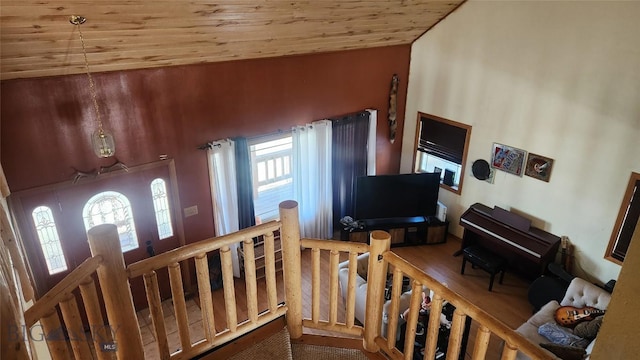 interior space featuring wood finished floors, lofted ceiling, plenty of natural light, and wooden ceiling