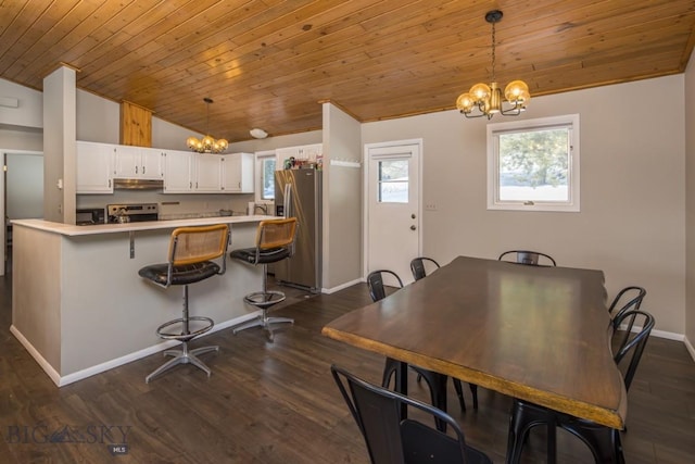 dining space featuring a chandelier, baseboards, dark wood-type flooring, and lofted ceiling