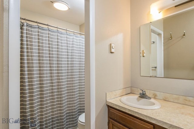 full bathroom with vanity, a shower with shower curtain, and toilet