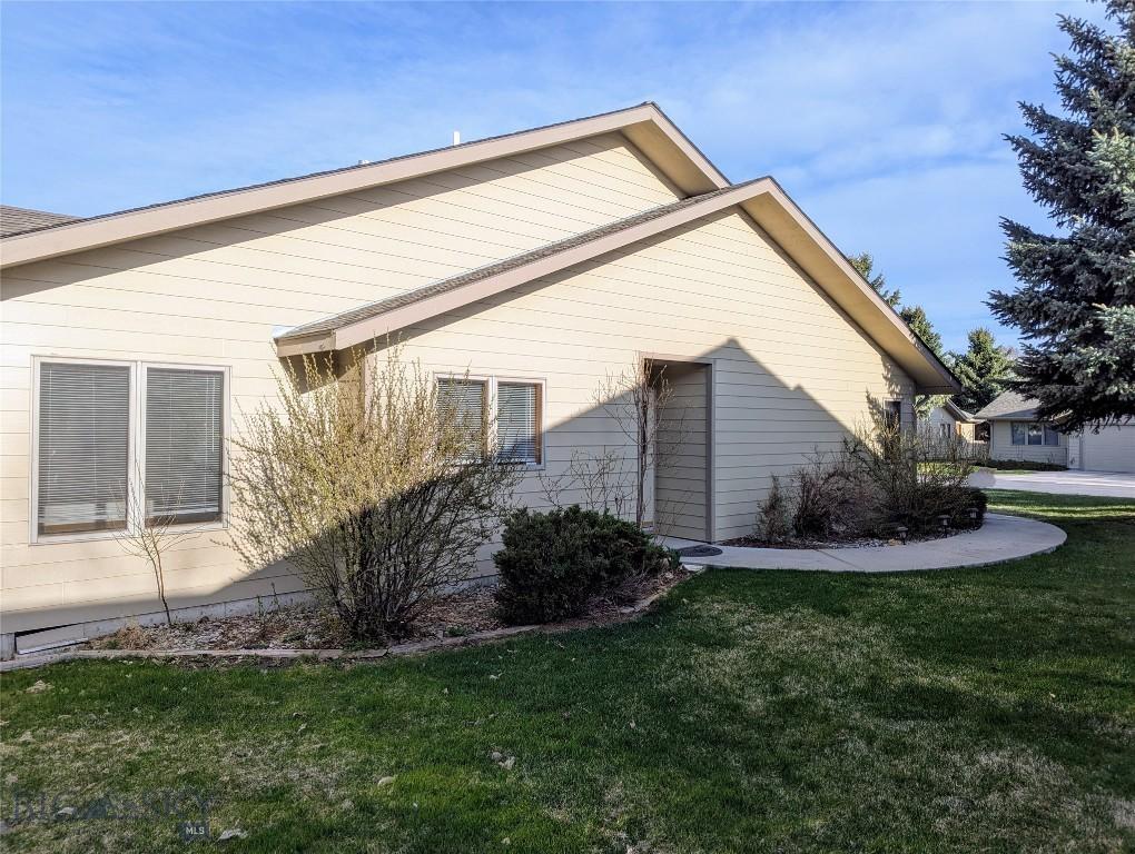 view of side of home featuring a yard
