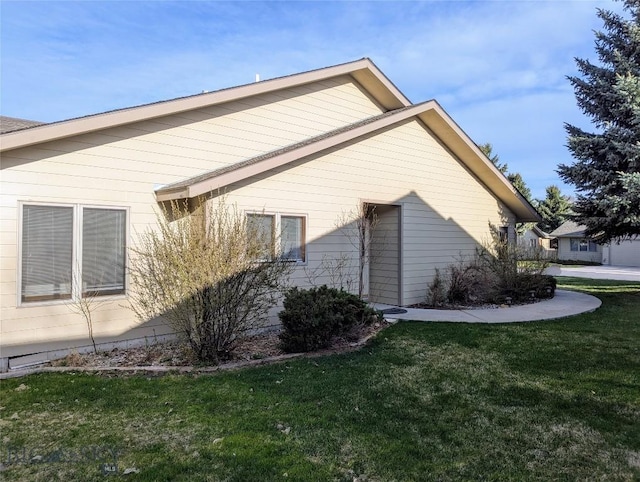 view of side of home featuring a yard