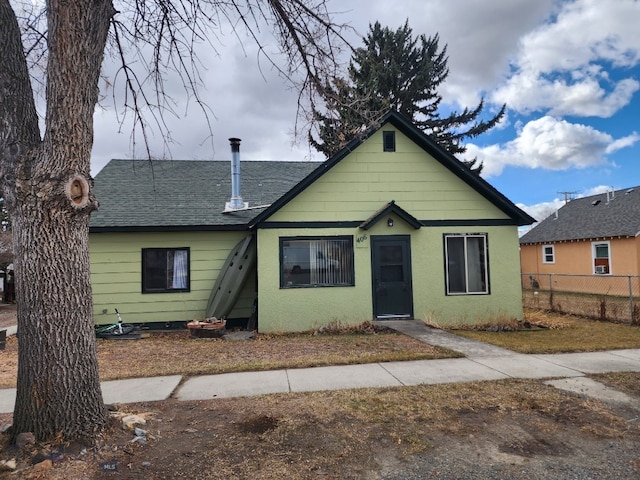 406 1st W, Whitehall, MT 59759 - bungalow-style home with fence, roof with shingles, and stucco siding