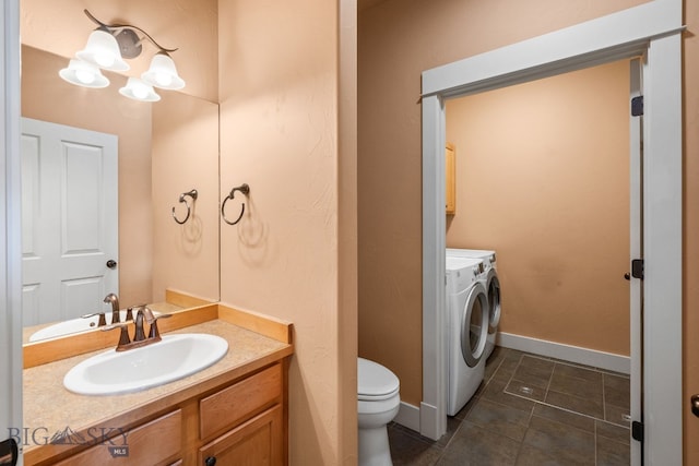 2236 Gallatin Green Blvd Unit C, Bozeman, MT 59718 - bathroom with separate washer and dryer, toilet, tile patterned flooring, vanity, and baseboards